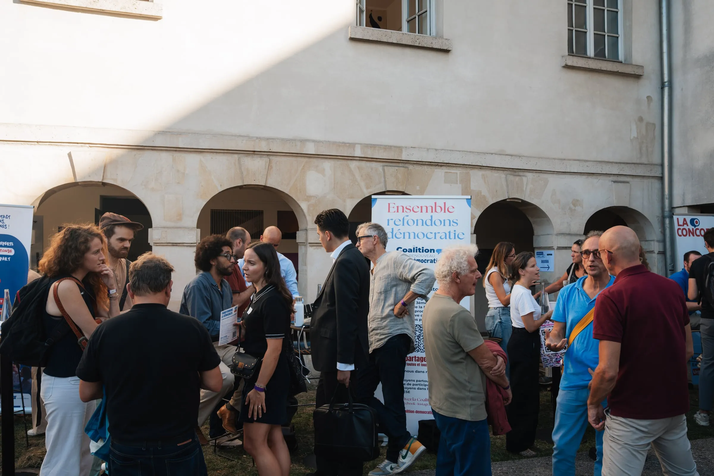 Le public dans la cour du Café A, entre les stands et les kakémonos des partenaires.